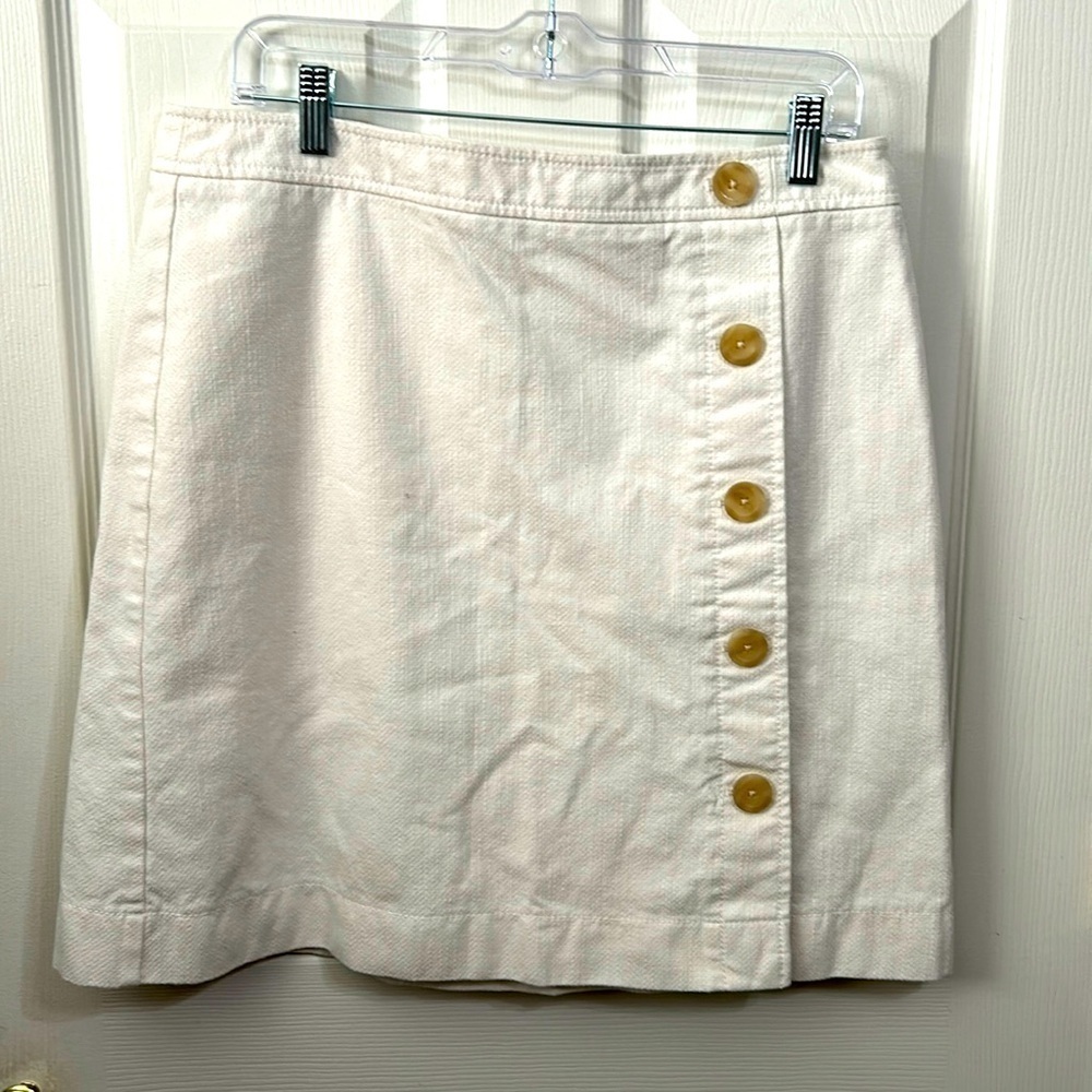Ann Taylor skirt. Cream. Decorative buttons down the front. Size 12
